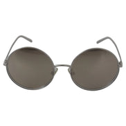 Round metal frame sunglasses with dark tinted lenses, modern luxury eyewear
