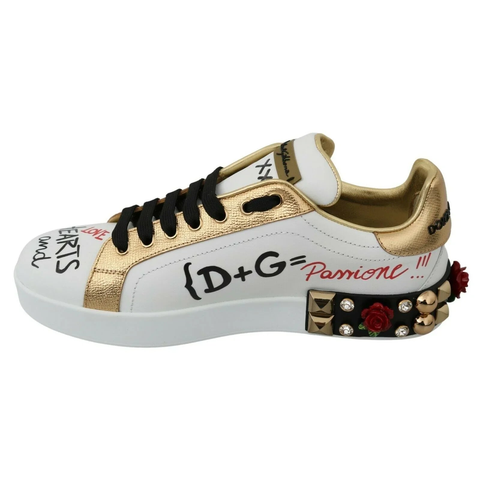 Designer white sneaker with gold metallic accents, graffiti text, black laces, and studded rose details