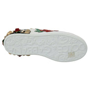 White designer sneaker sole with embossed floral pattern, colorful embellishments, and studs