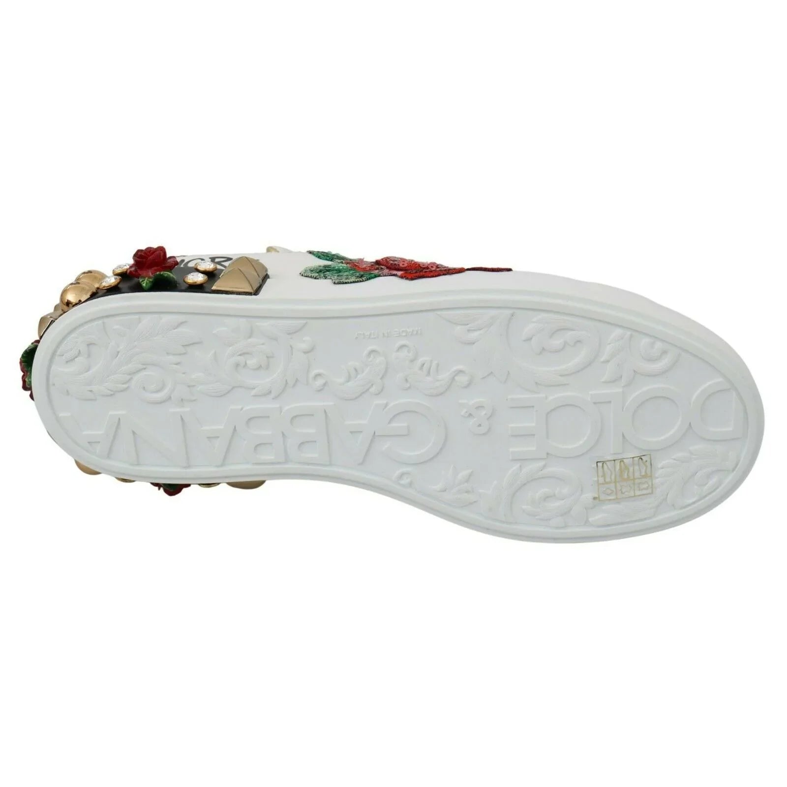 White designer sneaker sole with embossed floral pattern, colorful embellishments, and studs