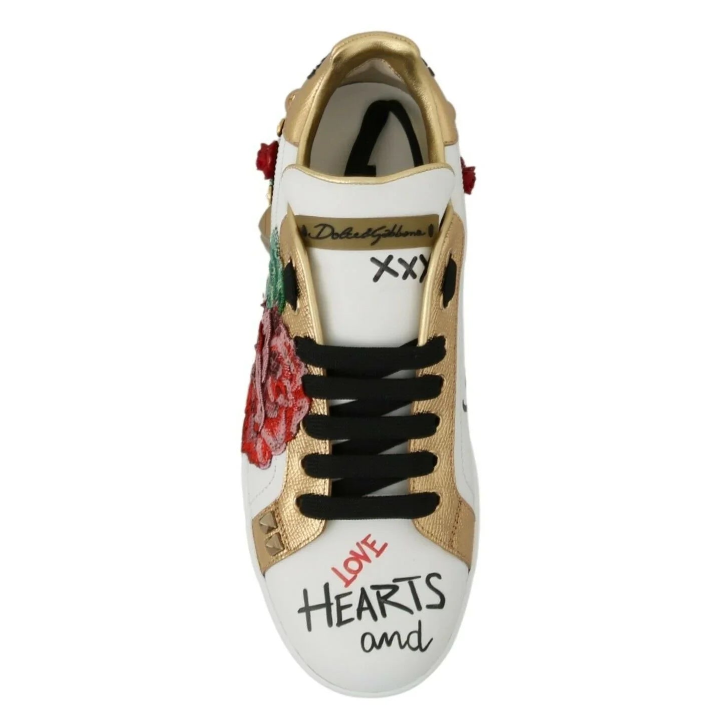 White and gold designer sneaker with black laces, red rose patch, and 'Love Hearts' text on toe