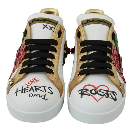 White sneakers with gold accents, black laces, and graphic text reading 'Love Hearts and Roses'.
