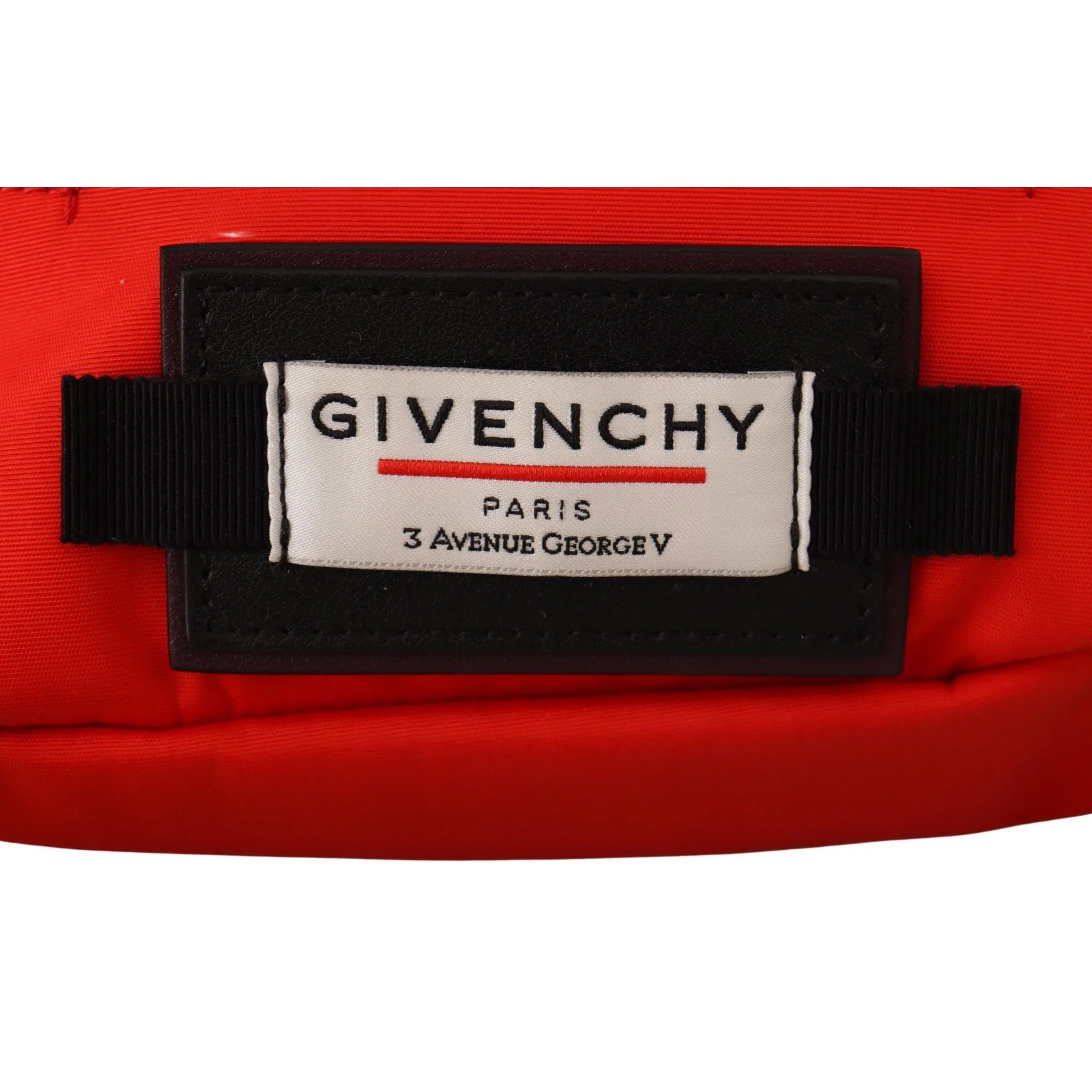 Close-up of Givenchy Paris logo patch on a red designer bag