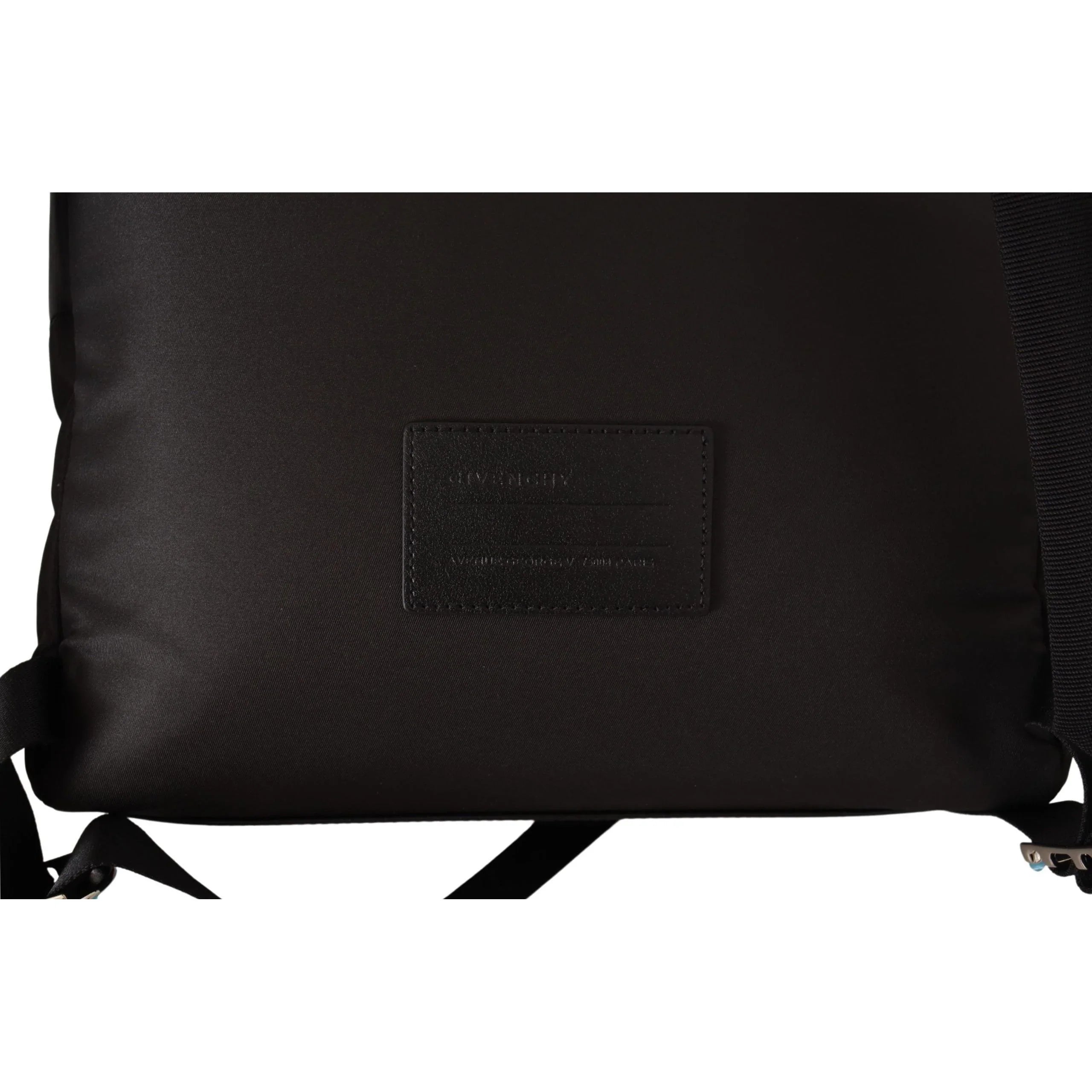 Close-up of black designer backpack with leather patch and adjustable straps