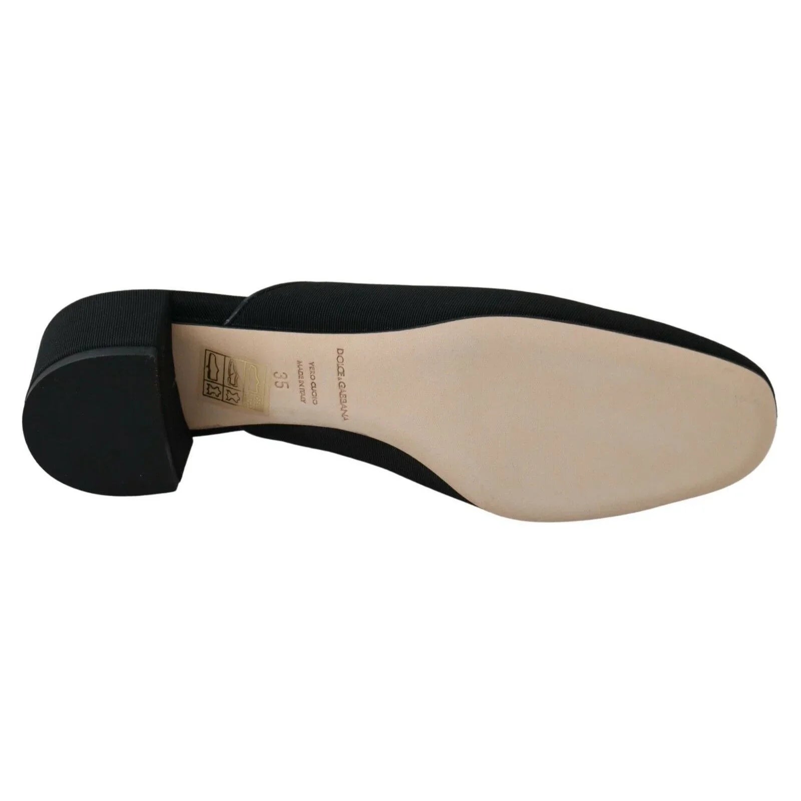 Black low heel women's shoe with beige leather sole and visible designer branding