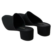 Black heeled mules with square toe and block heel on white background