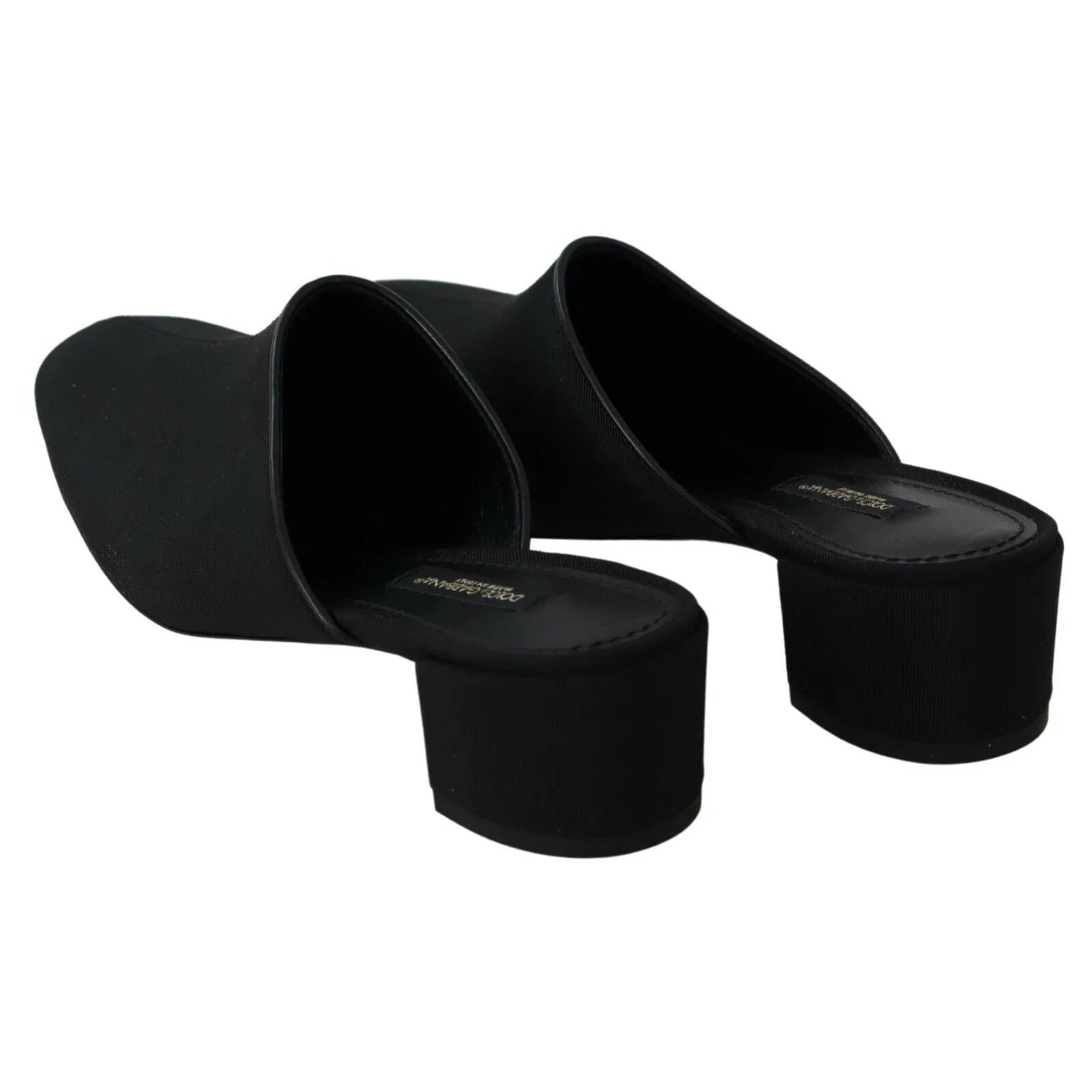 Black heeled mules with square toe and block heel on white background