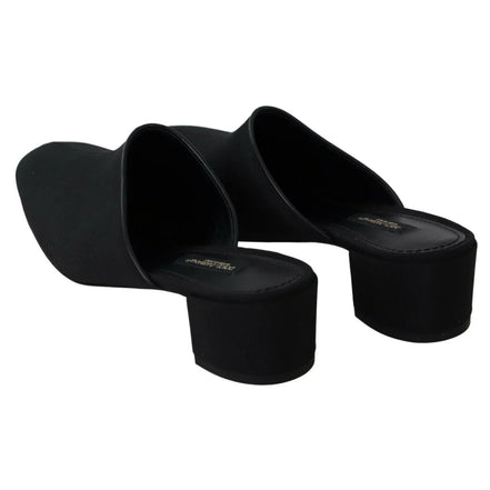 Black heeled mules with square toe and block heel on white background