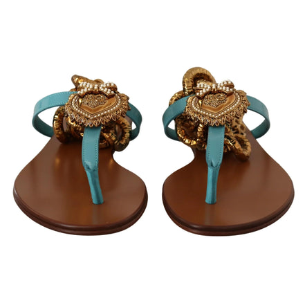 Turquoise leather sandals with gold heart embellishments and brown soles, front view