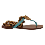 Luxury flat sandal with turquoise leather strap and gold ornate chain embellishment