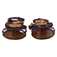 Purple strappy sandals with gold ornate embellishments and brown soles, luxury designer style