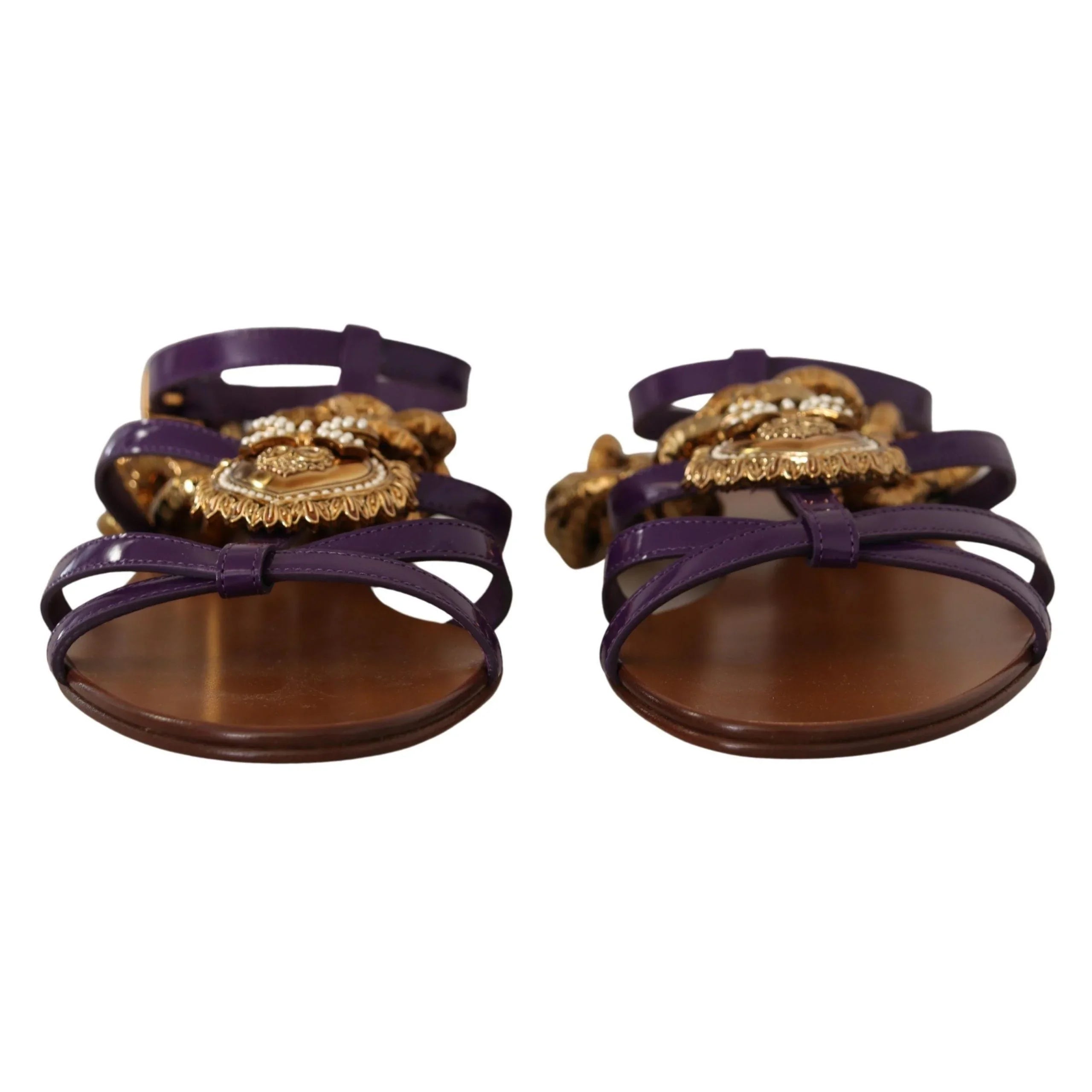 Purple strappy sandals with gold ornate embellishments and brown soles, luxury designer style
