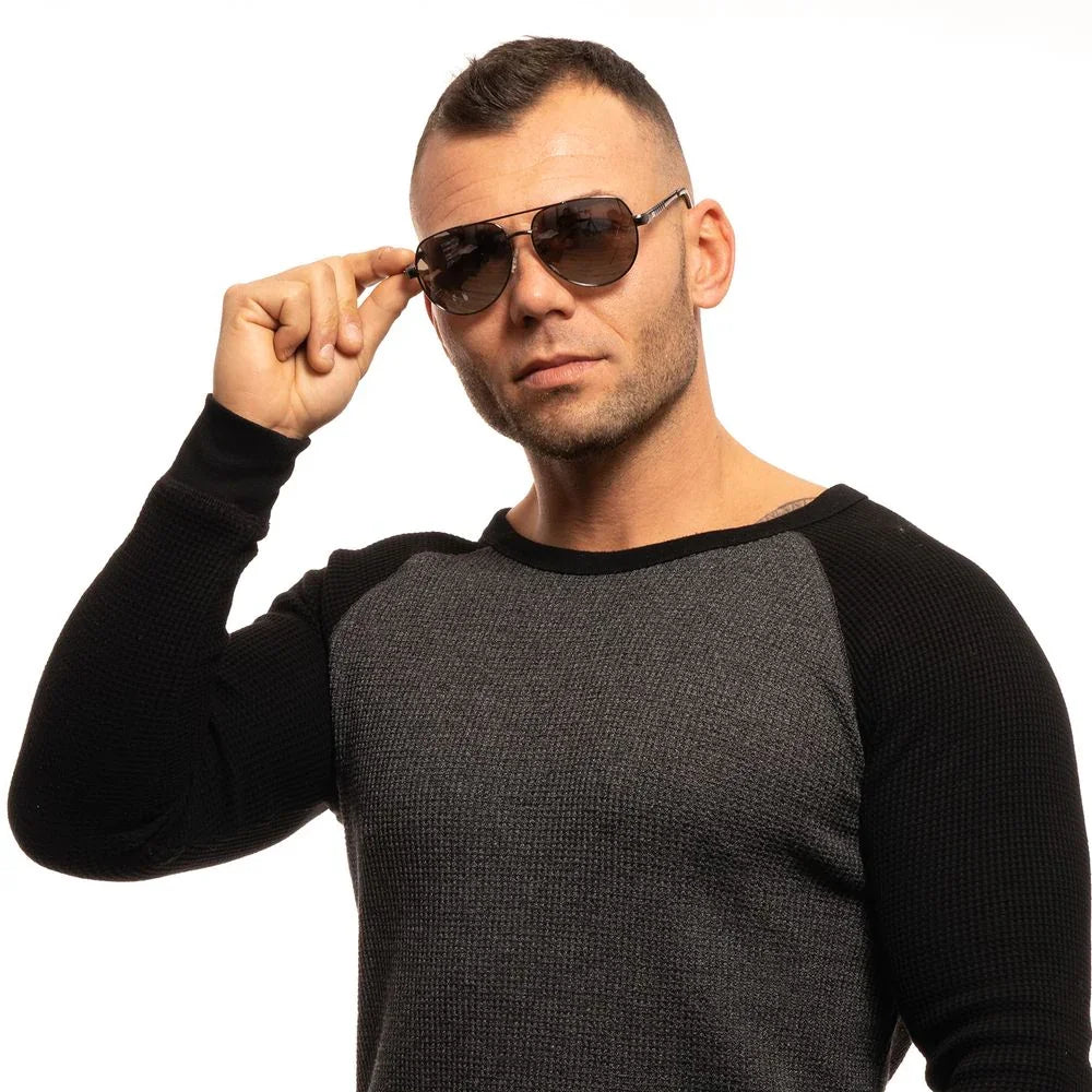 Man in aviator sunglasses and two-tone sweater posing against white background