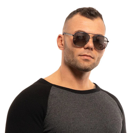 Man wearing stylish aviator sunglasses and a casual two-tone sweater on white background