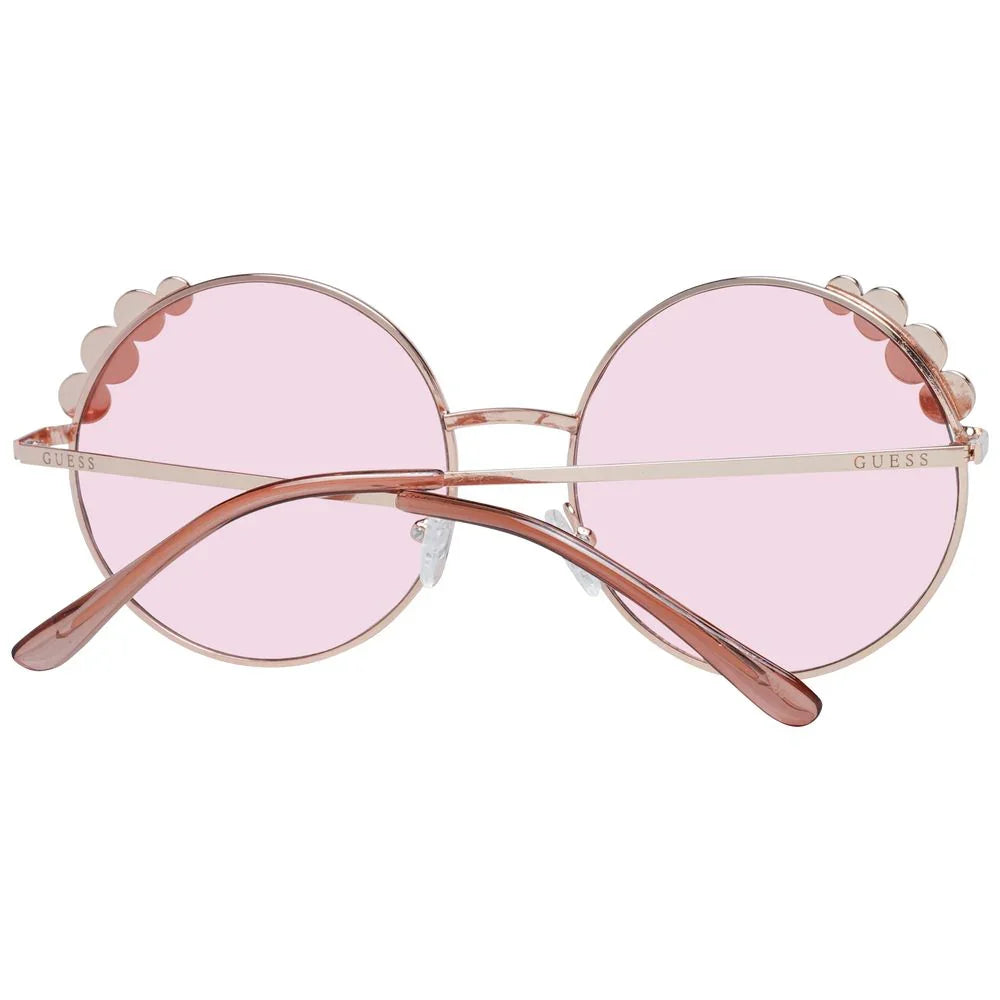 Round pink sunglasses with scalloped metal rims and rose gold frames, viewed from behind.