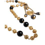 Collana Dolce & Gabbana stile rosario con perline nere e catena in ottone color oro