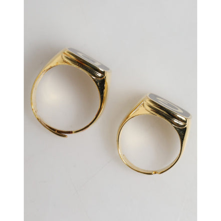 Anelli regolabili Dolce & Gabbana color oro in ottone nero smaltato con logo "DG"