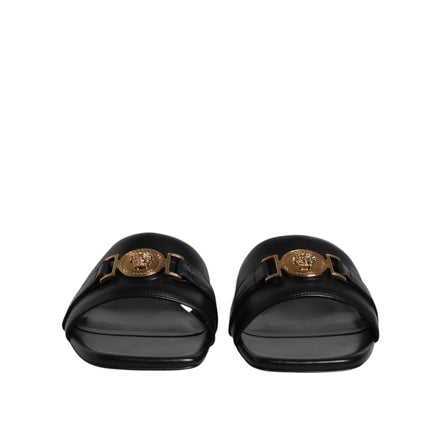 Versace Sandales plates en cuir noir à logo