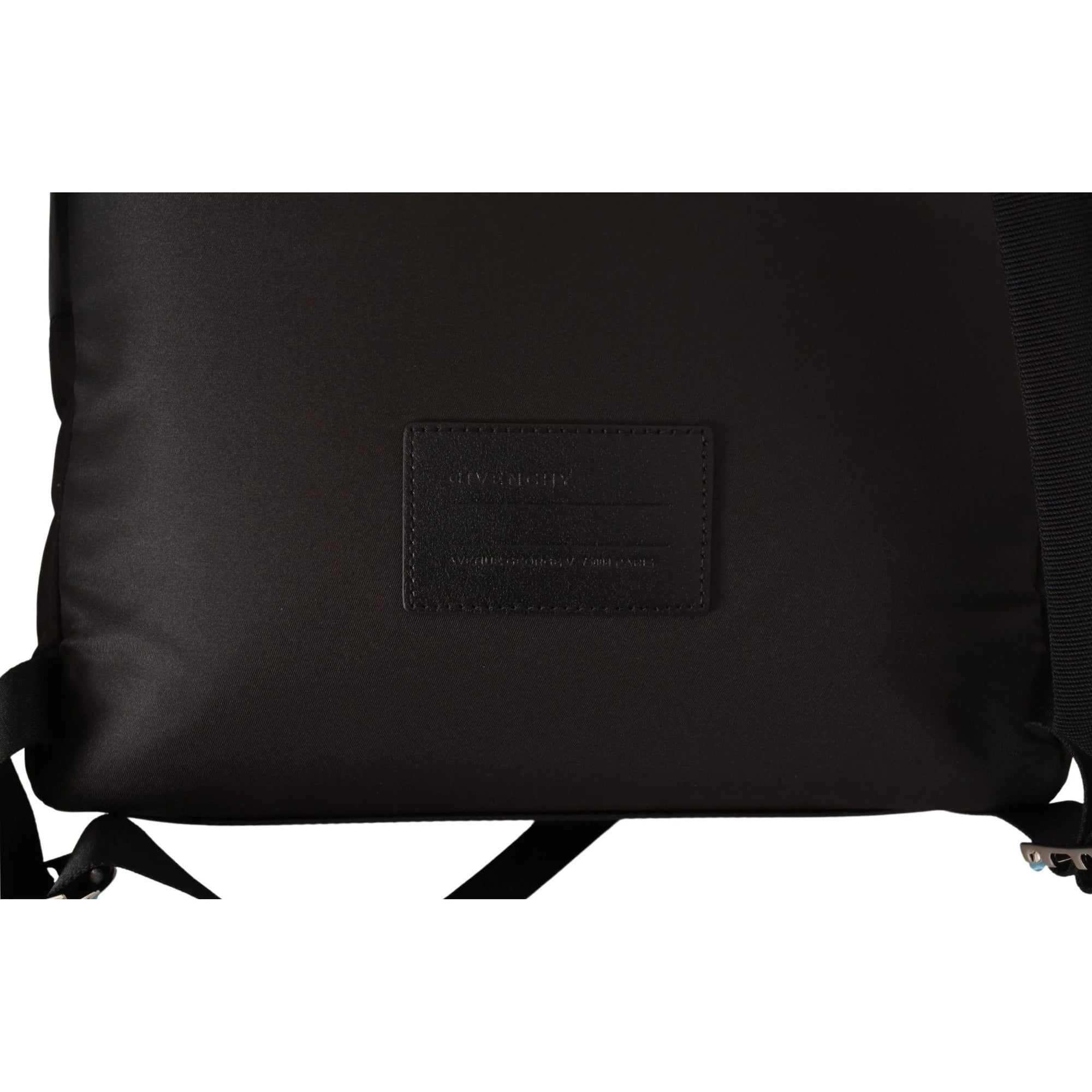 Close-up of black designer backpack with leather patch and adjustable straps
